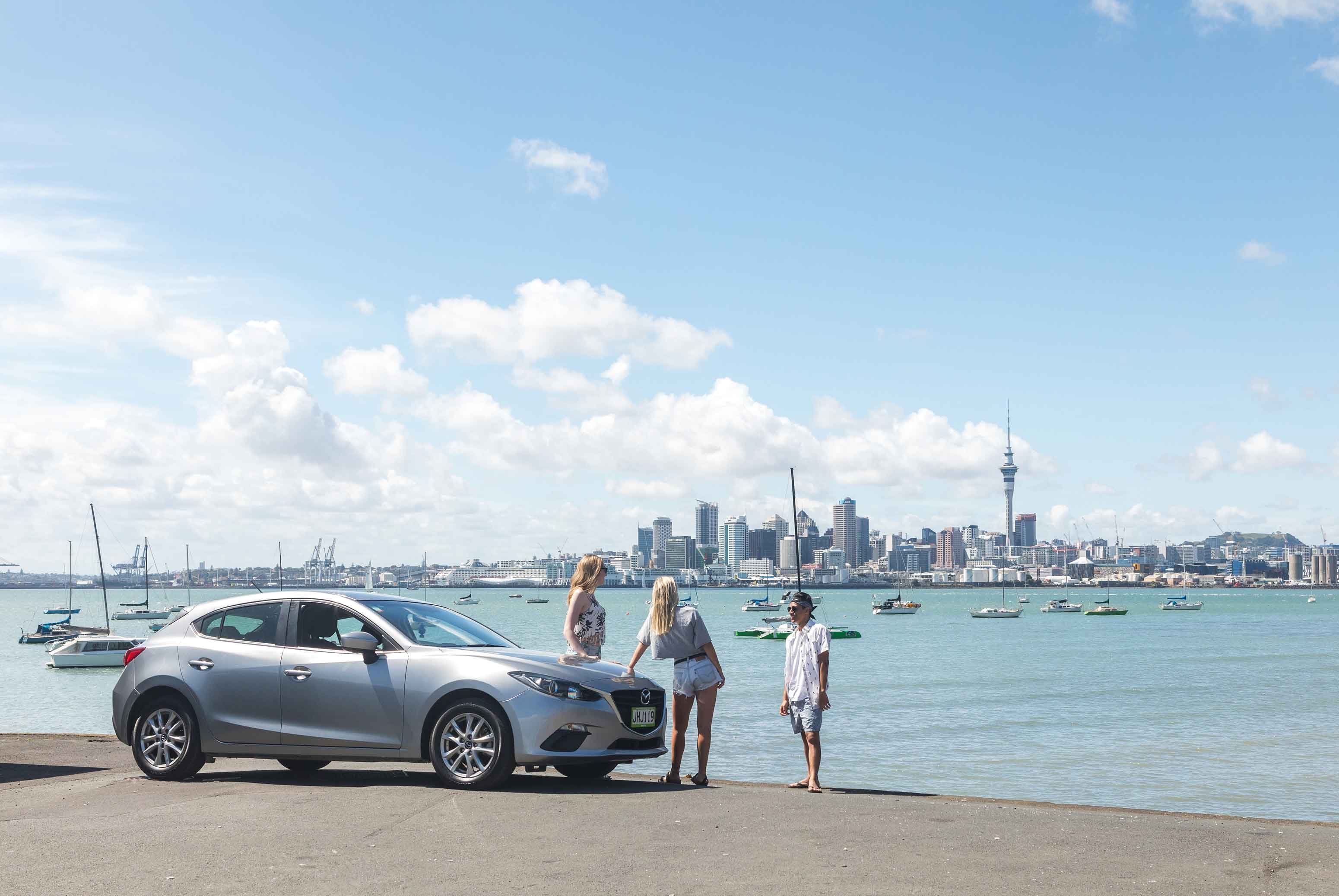 mid hatch with three friends against auckland city backdrop